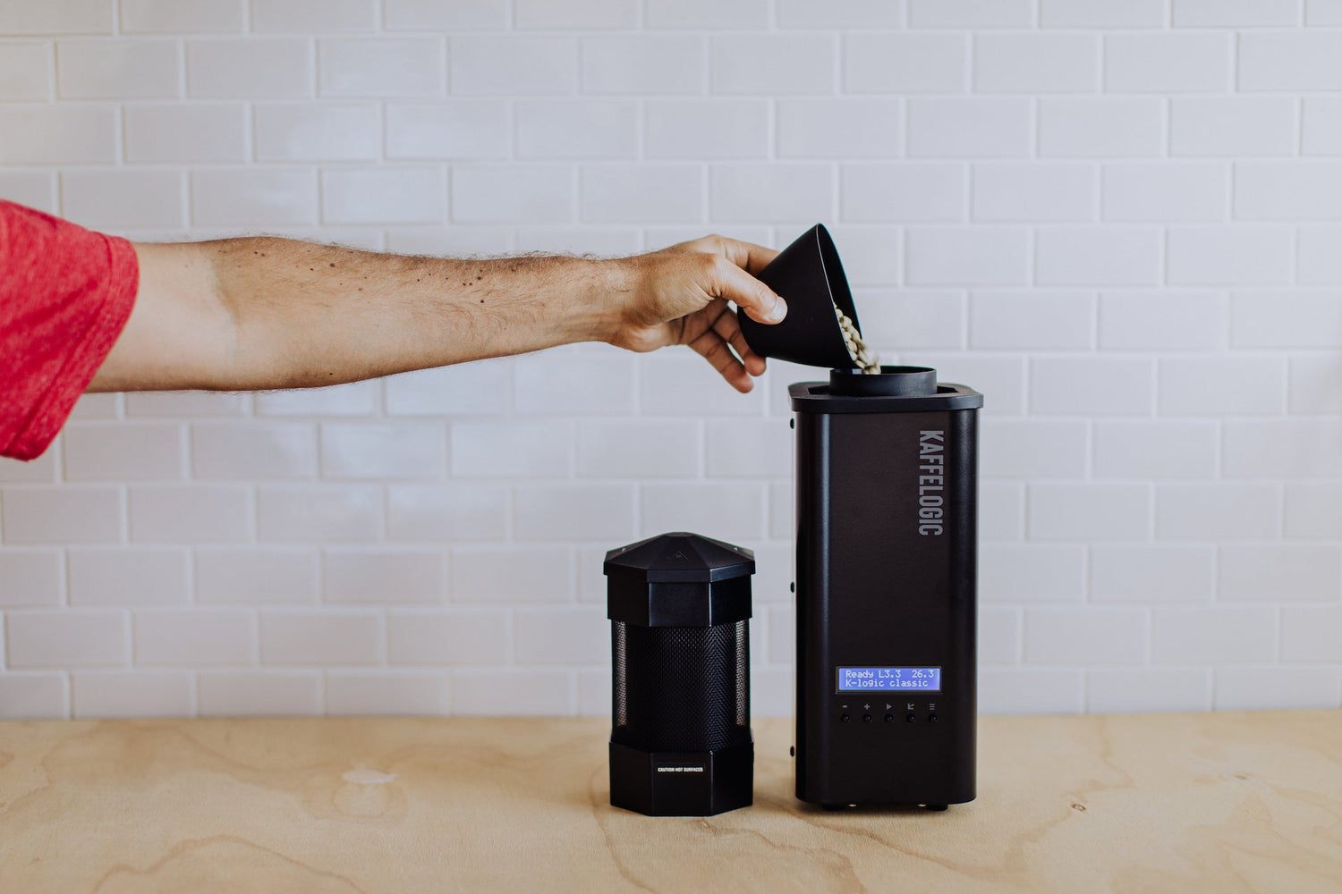 green coffee being poured into the Kaffelogic Nano 7 Roaster